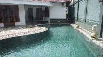 Gambar 1 A 1 storey, 4 bedroom, stand alone house located in Cilandak, Jakarta with 4 bathrooms, a pool and a yard