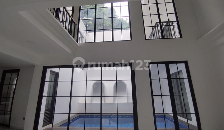 American Style Luxurious House with a Strategic Comfortable Swimming Pool and Wide Road