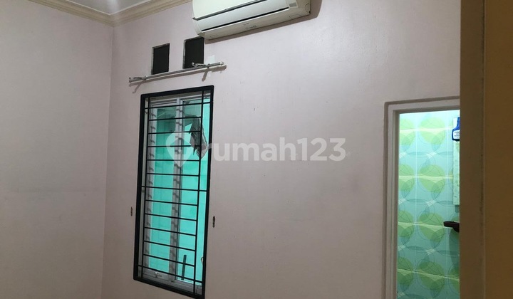 House in Griya Loka BSD City with front view of public facilities land and garden. 2