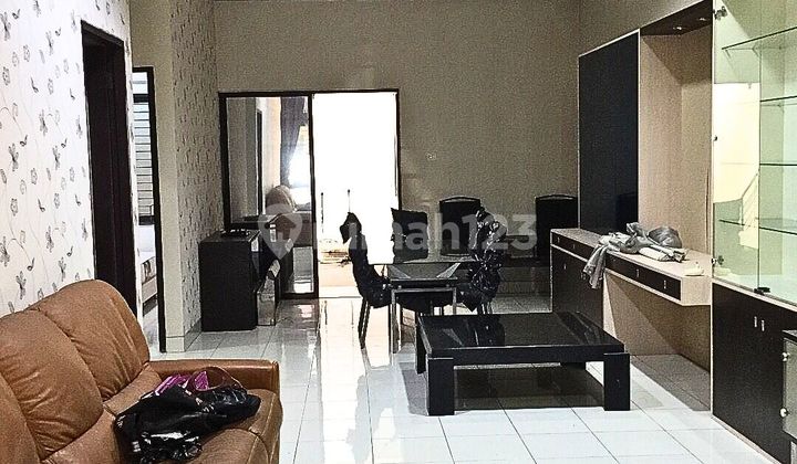 Ivory Garden House Surrounded by Lush Trees in Lippo Cikarang