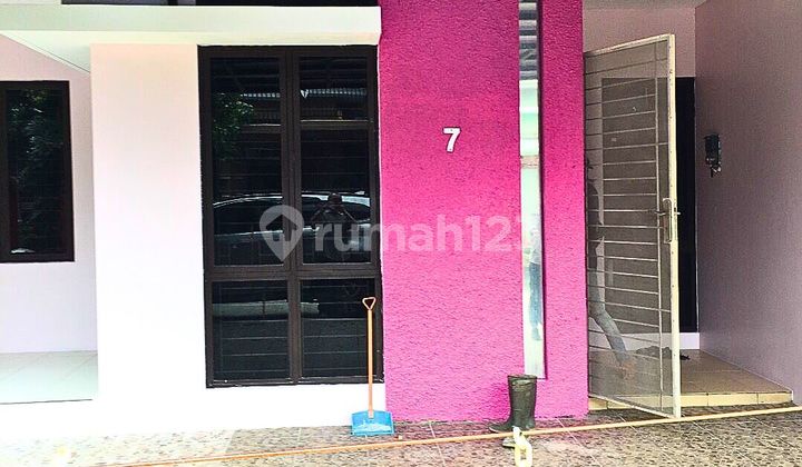 Ivory Garden House Surrounded by Lush Trees in Lippo Cikarang