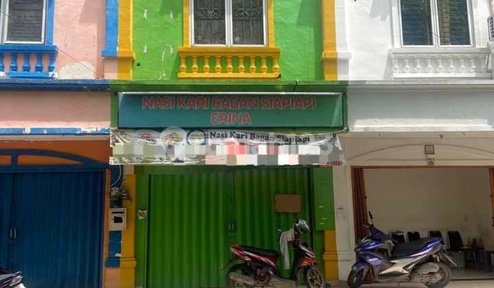 Taman Surya 5, Pegadungan, Kalideres, West Jakarta.. For Rent: 2-floor shophouse. Minimum rental period 2 years, Deposit 10 million IDR. Photo shows a glass door, but currently the glass door is no longer there. Facing south, PLN electricity 5500W, water from WTP (Water Treatment Plant).-R0b 1