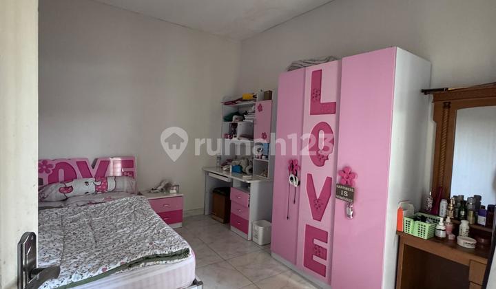 A 2-story house with 5 bedrooms near the toll road in Graha Raya. 2