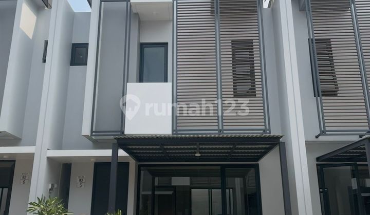 For Rent: Mayza Cluster Housing, 5x12, 2 floors, 3 bedrooms, 2 bathrooms, 1 car garage in front, double car access, neat and nice house. Includes 3 AC units, built-in gas stove, washing machine, water heater, dining table with chairs, sofa, 2 beds, refrigerator, 50-inch TV, office desk, and wardrobe.