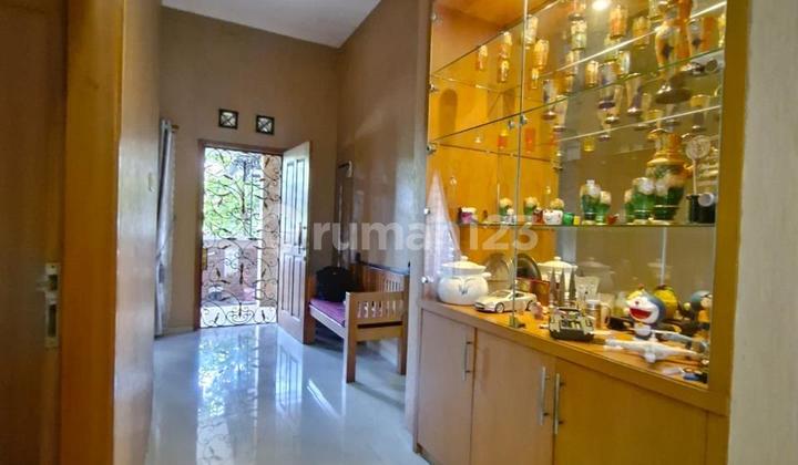 2-Story House with Large Front Balcony facing Garden in Nusaloka 2