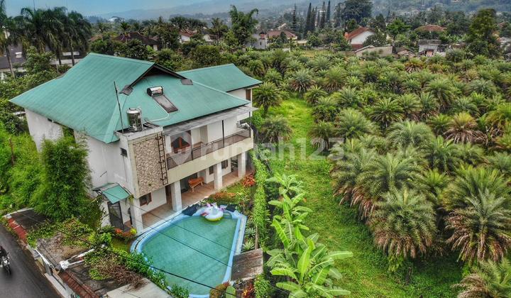 For Sale Villa in Cisarua Puncak, Land Area 1600M2, Building Area 610M2, 2 Floors, 6 BR (6 Ensuite Bathrooms) (1st Floor = 1 Room, 2nd Floor = 5 Rooms) Facilities: - Fully Furnished Beds, Furniture, TV (Neat and Clean Condition, Ready to Rent) - Nice View (Mountain View) - Swimming Pool Available