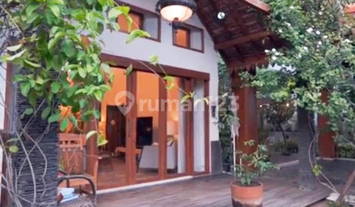 A house on Jl. Bedadung in Central Surabaya with a Balinese ambiance, featuring a swimming pool and a spacious, serene yard, making it comfortable to live in.