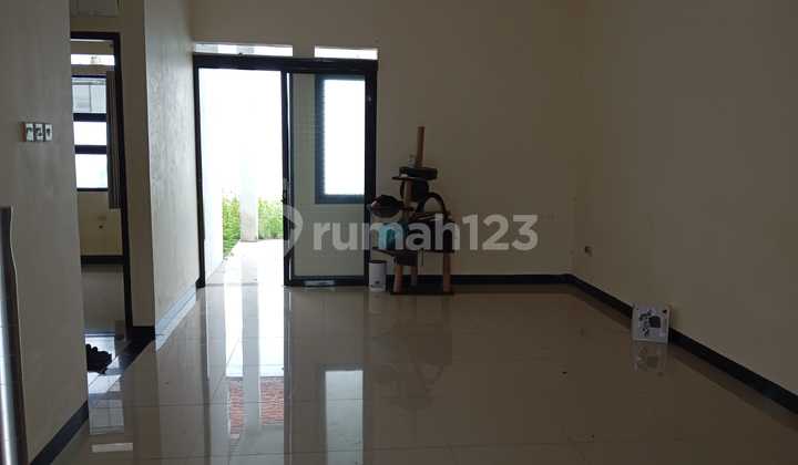 Minimalist House in Cihanjuang Cluster with Open Space and Backyard Garden 2