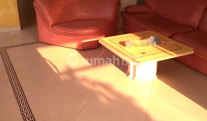 A charming one-story house ready for occupancy with a large vacant land area.