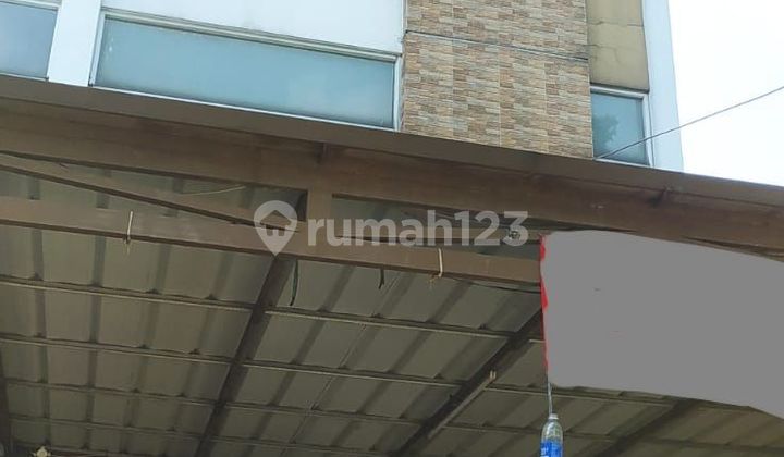 Three-story shop house on Holis main road.