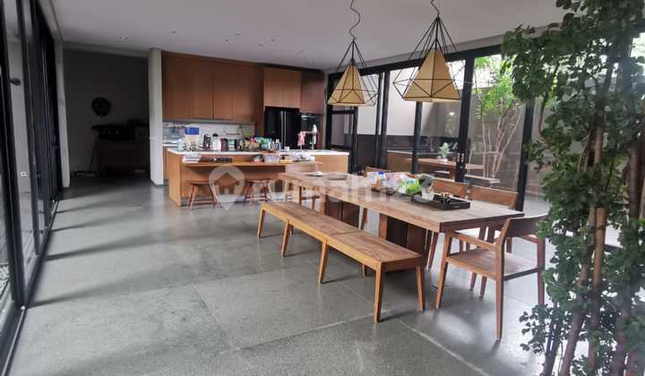 Luxury Home with Natural Stone and Ulin Wood Touches, Featuring a Lush and Comfortable Pool in Alam Sutera. 2